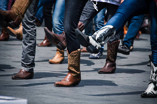 What makes modern cowboy boots suitable for work and leisure in today's fashion?